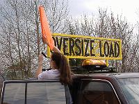 Travelers&Kaite  BTI's Kaite is demonstrating how easy it is to install the flags on a BTI oversize load sign.